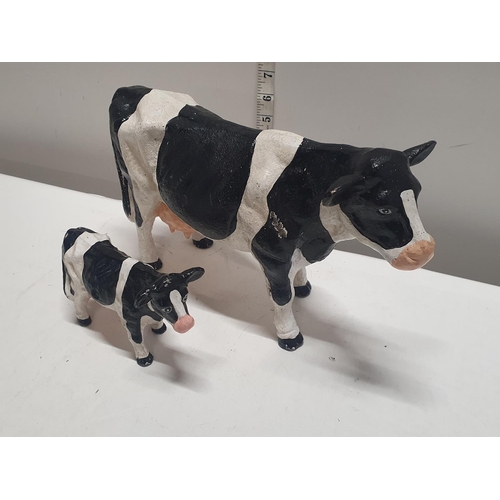 50 - Two heavy vintage cast cow figures largest 32x20cm, shipping unavailable