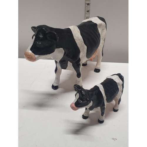 50 - Two heavy vintage cast cow figures largest 32x20cm, shipping unavailable