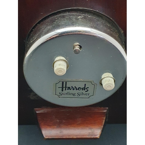 153 - A hallmarked silver framed mantle clock retailed by Harrods