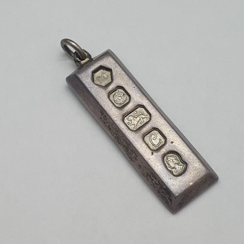 61 - A one ounce silver ingot in the form of a locket.