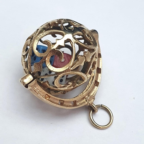 69 - An unusual hallmarked 9ct gold ball pendant containing three minature dice. 5.35 grams gross weight.