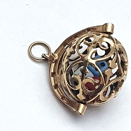 69 - An unusual hallmarked 9ct gold ball pendant containing three minature dice. 5.35 grams gross weight.