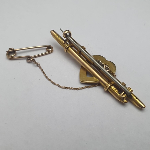 79 - A antique 15ct gold bar brooch on a 9ct gold safety chain. 4.00 grams