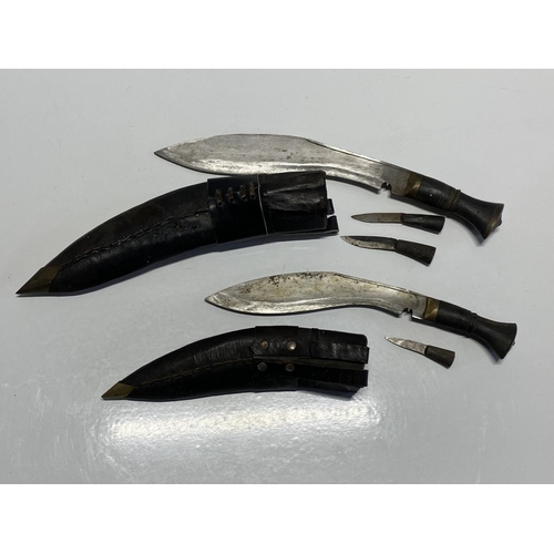 207 - Two sheathed Kurki knifes in leather scabbards with skinning knives, shipping unavailable