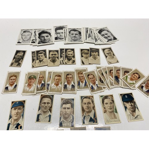 143A - A selection of vintage and antique sporting cigarette cards including football, cricket including a ... 