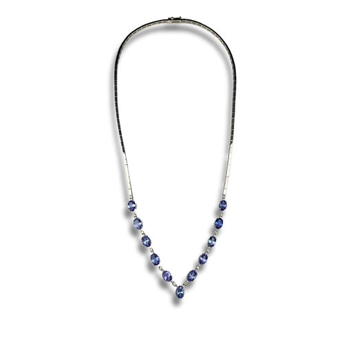 121 - A 18ct white gold necklace set with tanzanite & diamonds. Gross weight 18.42 grams. With cert.