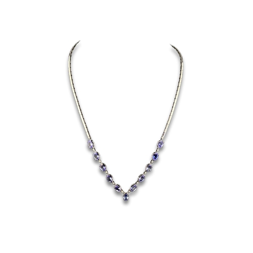 121 - A 18ct white gold necklace set with tanzanite & diamonds. Gross weight 18.42 grams. With cert.