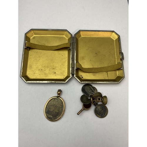 140 - A vintage cigarette case, gold tone pendant and other