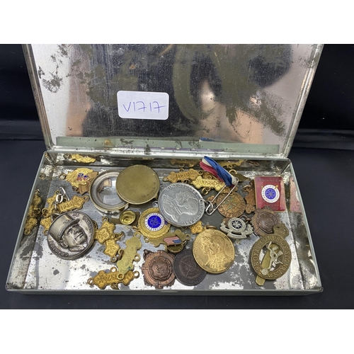 141 - A selection of military related badges, medals and other items.