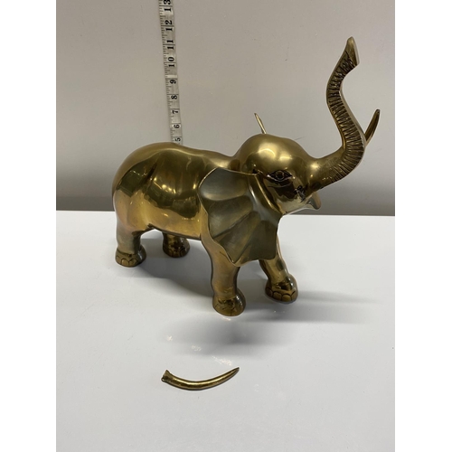 21 - A heavy brass elephant (one tusk needs reattaching), shipping unavailable