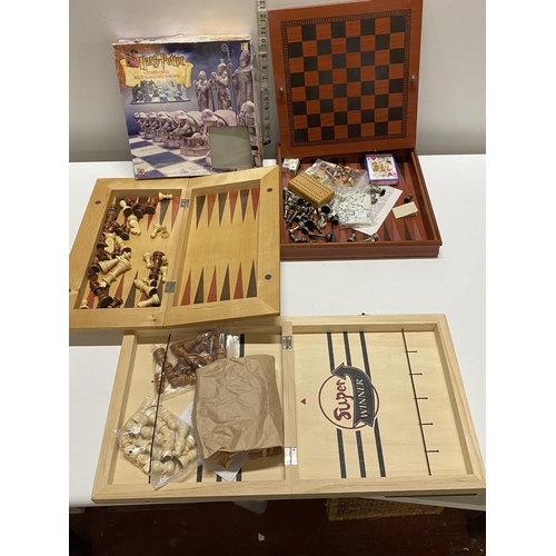 303 - A selection of various chess boards and gaming sets complete including Harry Potter