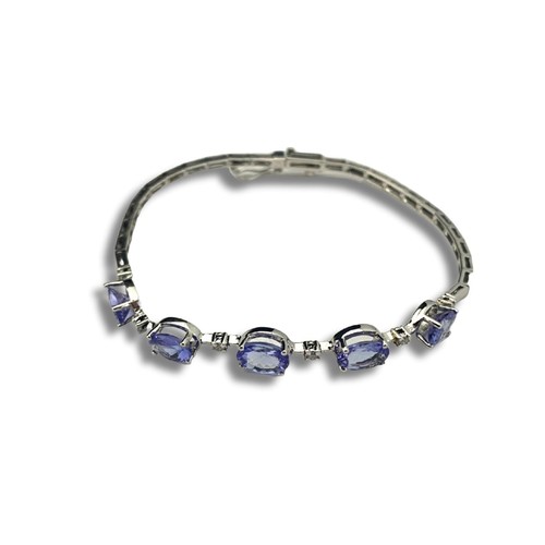 121A - A 18ct white gold Tanzanite & diamond bracelet. Gross weight 7.31 grams.