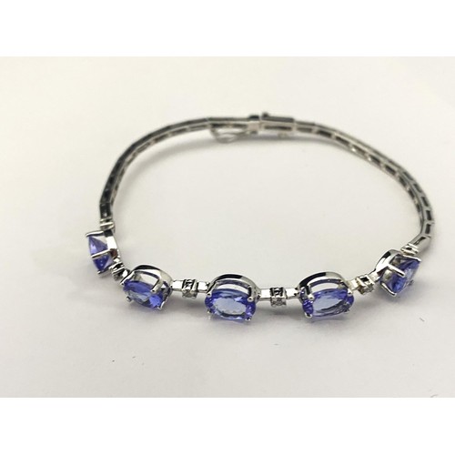 121A - A 18ct white gold Tanzanite & diamond bracelet. Gross weight 7.31 grams.