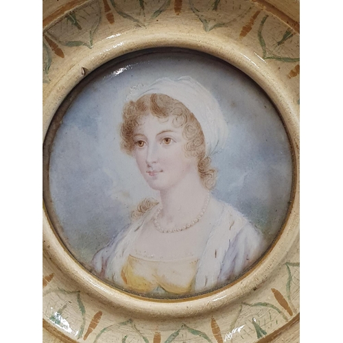 103 - A Georgian painted miniature portrait of a young lady in a round frame to reverse 'Lady Armitage' ov... 