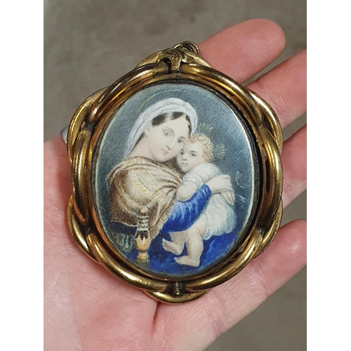 112 - A early 19th century painted miniature portrait depicting a mother and child in a ornate brass frame... 