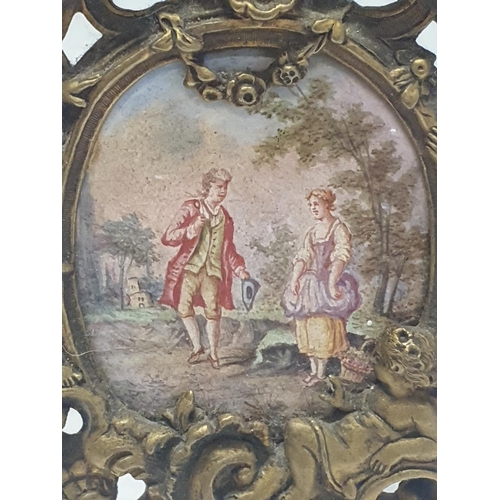 62 - A hand painted miniature portrait of a Georgian couple housed in a brass frame with small time piece... 