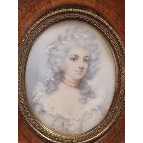 66 - A Georgian hand painted miniature of a young lady in a oak oval frame overall dimensions 13x11cm