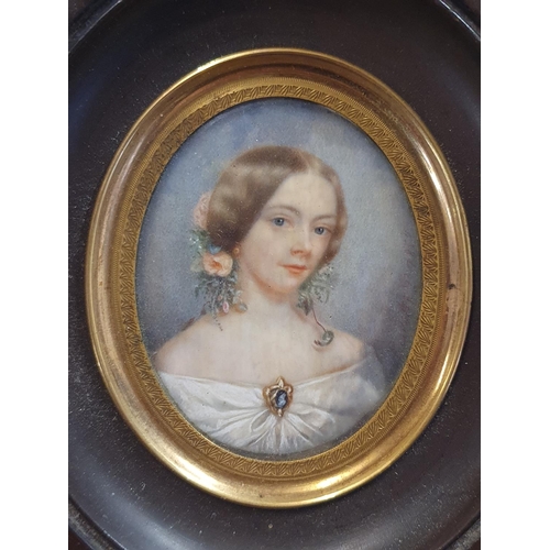 73 - A 19th century hand painted miniature portrait of a young lady with lock of hair attached to reverse... 