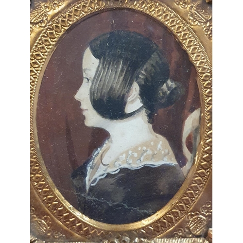 93 - A early Victorian framed miniature portrait of a lady possibly a memorial portrait with crests to fr... 