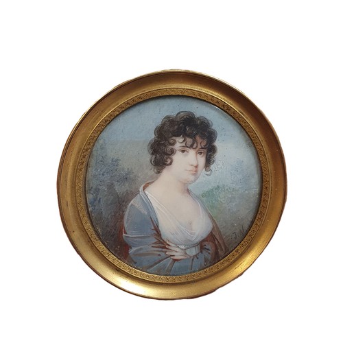 88 - A Georgian painted portrait miniature in a round brass frame (signature illegible) overall diameter ... 