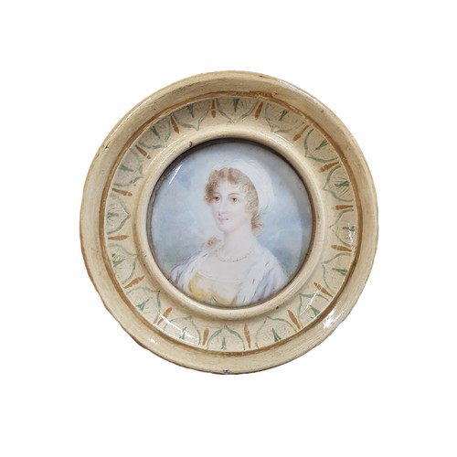 103 - A Georgian painted miniature portrait of a young lady in a round frame to reverse 'Lady Armitage' ov... 