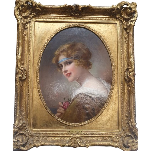 36 - A early 20th century oil on canvas depicting a portrait of a young lady holding a rose by French art... 