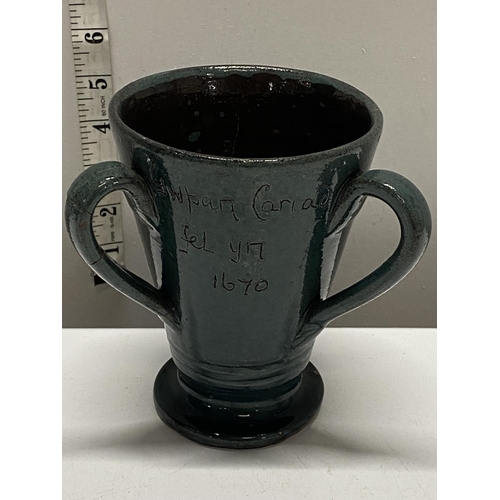 240 - A traditional Welsh loving cup by the claypits pottery. With welsh inscription to front 