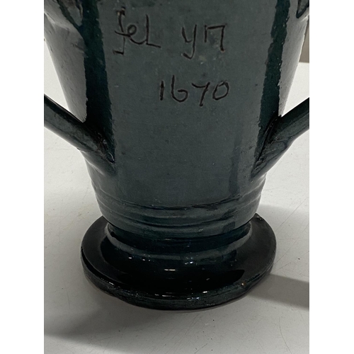 240 - A traditional Welsh loving cup by the claypits pottery. With welsh inscription to front 