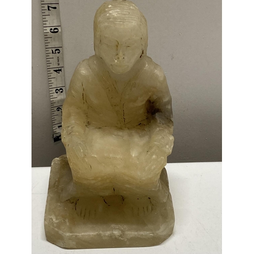 241 - An large antique carved alabaster seated oriental figure.