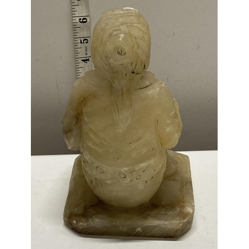 241 - An large antique carved alabaster seated oriental figure.