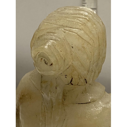 241 - An large antique carved alabaster seated oriental figure.