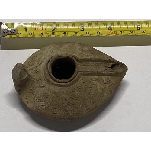 202 - A 12th century Persian Seljuk empire, fired clay oil lamp with grape decoration.