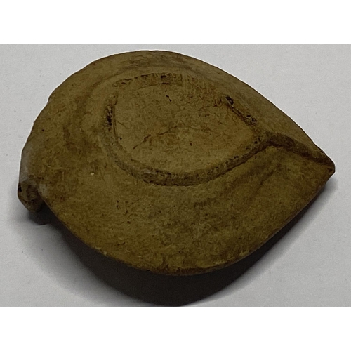 202 - A 12th century Persian Seljuk empire, fired clay oil lamp with grape decoration.