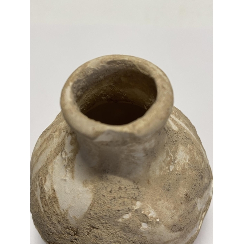 207 - A antique Greco Roman clay vessel. 7cm tall.