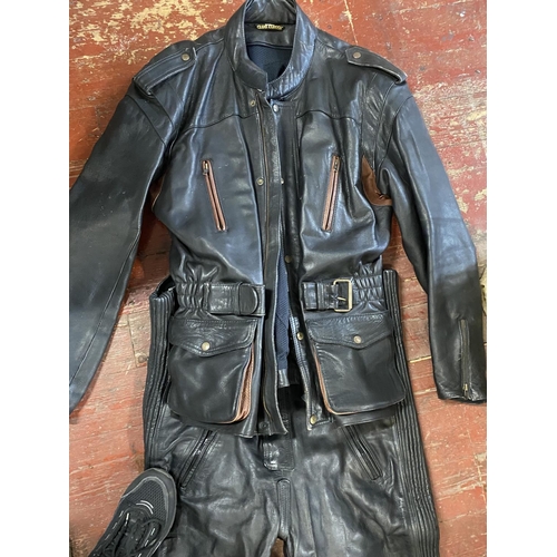 569 - A pair of Belstaff motorbike gloves, a vintage motorbike jacket and leather salopettes