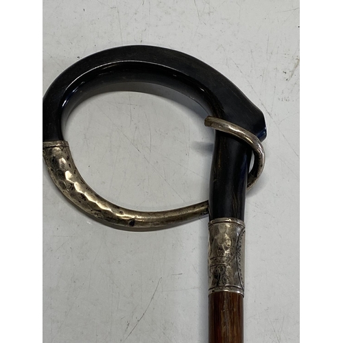 607 - A antique horn and silver handled walking cane