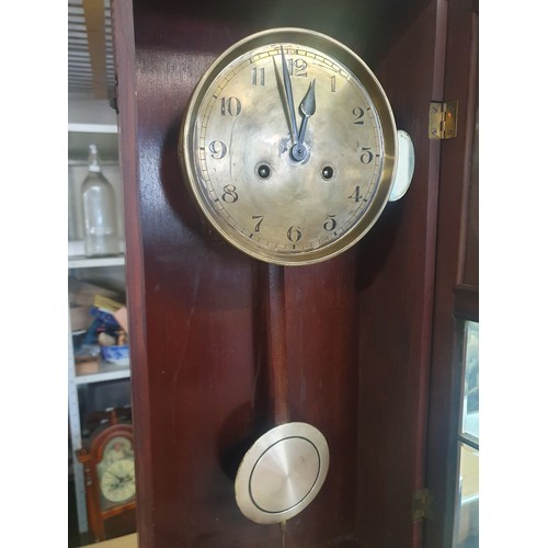 89A - A vintage wooden cased wall clock with key and pendulum, shipping unavailable