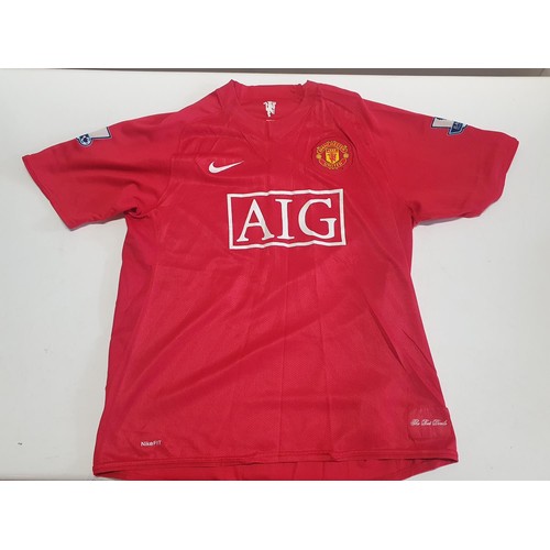 346 - A large selection of mainly new old stock Manchester United football shirts - mostly L and XL sizes ... 