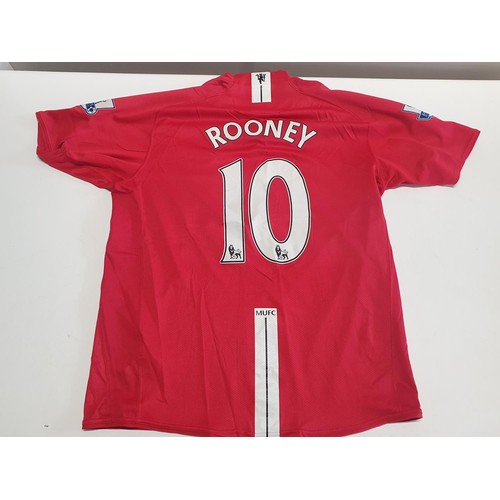 346 - A large selection of mainly new old stock Manchester United football shirts - mostly L and XL sizes ... 