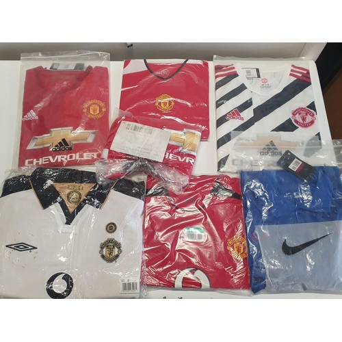 346 - A large selection of mainly new old stock Manchester United football shirts - mostly L and XL sizes ... 