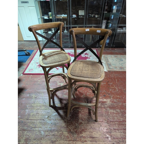 66 - A Pair of Bentwood-Style Oak and Cane Cross-Back Bar Stools. 112cm Tall. Shipping Unavailable