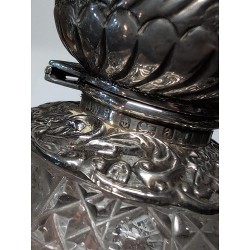 151 - Two Edwardian English Sterling Silver and Cut Glass Lidded Bottles. H 9cm, 7cm dia