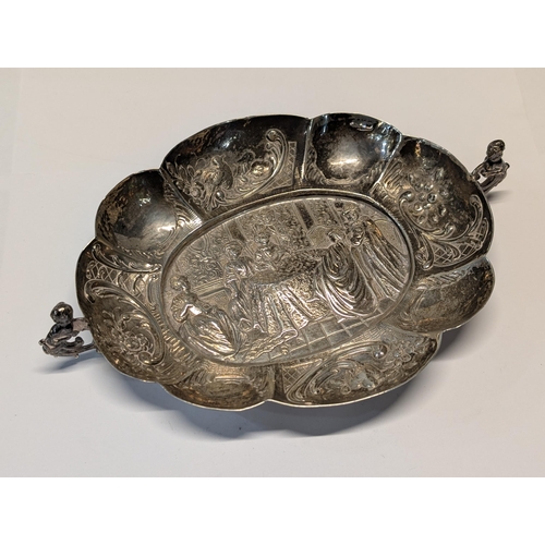 164 - Exeter 1862? Silver Repoussé Dish with Figural Putti Handles. H 3.5cm, L 19cm, W 13cm 148g
