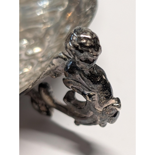164 - Exeter 1862? Silver Repoussé Dish with Figural Putti Handles. H 3.5cm, L 19cm, W 13cm 148g