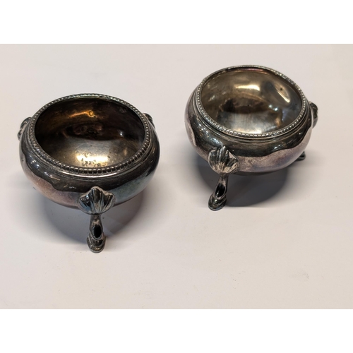 134 - A Pair of English Sterling Silver Three-Footed Salt Cellars. Worn Hallmarks, H 4cm, 7cm dia 124g