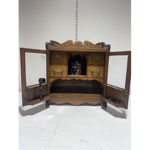 23 - Antique Edwardian Carved Oak Smokers Cabinet and contents.  46cm x 41cm x 19cm. No shipping.