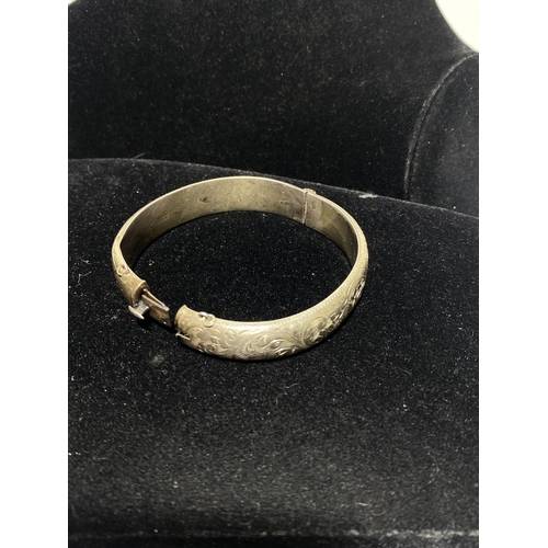 114 - Two Bangles including an Edwardian Hallmarked Sterling Silver Engraved Bangle and a Gemset White Met... 