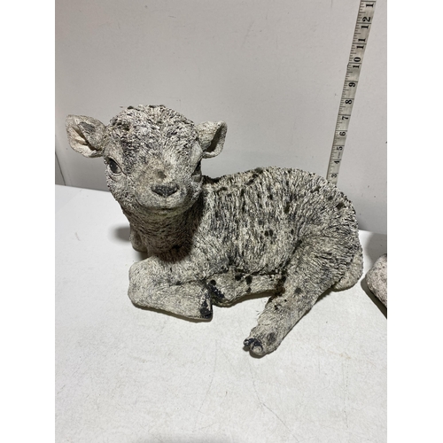 66 - A Pair of Cast Composite Recumbent Lamb Garden Ornaments. 26cm x 34cm. No shipping.