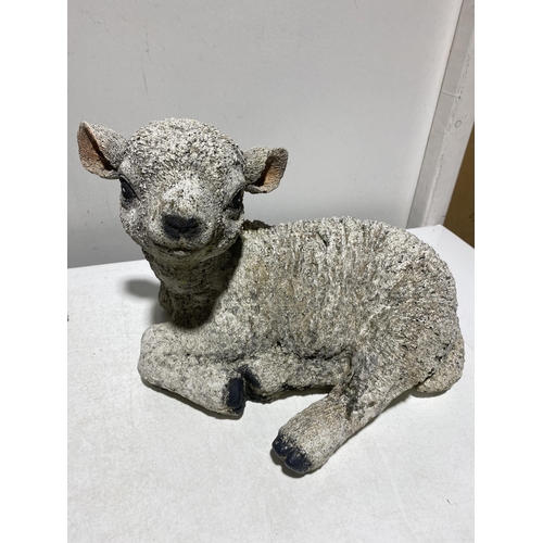 66 - A Pair of Cast Composite Recumbent Lamb Garden Ornaments. 26cm x 34cm. No shipping.