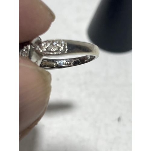 95 - A 14ct white gold ring with heart shaped black diamond centre piece surrounded by diamonds. size M. ... 